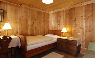 Das holzvertäfelte Einzelzimmer Kirche mit Einzelbett und rustikaler Einrichtung