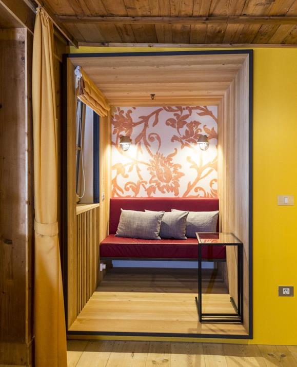 The reading corner in the Church double room with a cozy sofa and a lot of throw pillows